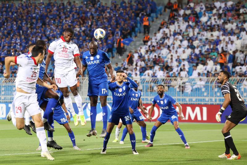 Sharjah forward Ousmane Camara heads the ball to score the opening goal.