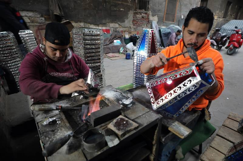 Egyptian craftsmen produce Ramadan lanterns, called fanous, at a workshop in Cairo. EPA