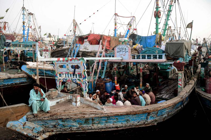 Fishermen break their fast on a boat in the port city of Karachi. AFP