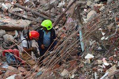 Rescue workers search for survivors in the rubble of a collapsed five-storey apartment building in Mahad, about 170 kilometres from India's financial capital of Mumbai in western Maharashtra state.  AFP