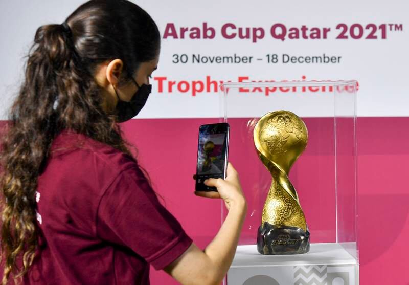 A woman takes a picture of the Fifa Arab Cup trophy displayed at Katara Cultural Village in Doha, Qatar, 25 November 2021.  All photos: EPA