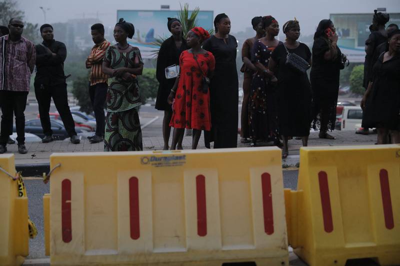 Family members wait for the arrival of the coffin containing the remains of former Ghana international football player Christian Atsu at the Kotoka International Airport in Accra, Ghana. AFP