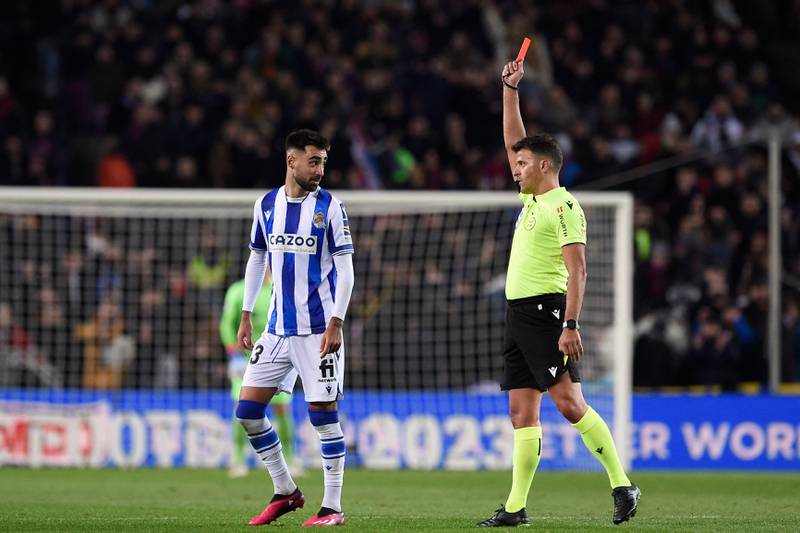 Referee Gil Manzano shows a red card to Real Sociedad's Spanish midfielder Brais Mendez. AFP