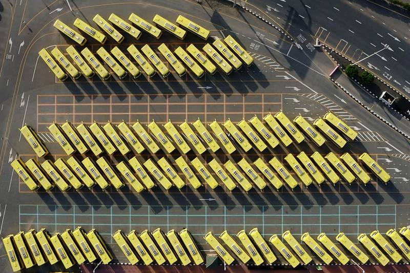 A drone image shows school buses parked in a lot in Dubai, during the coronavirus pandemic.  AFP