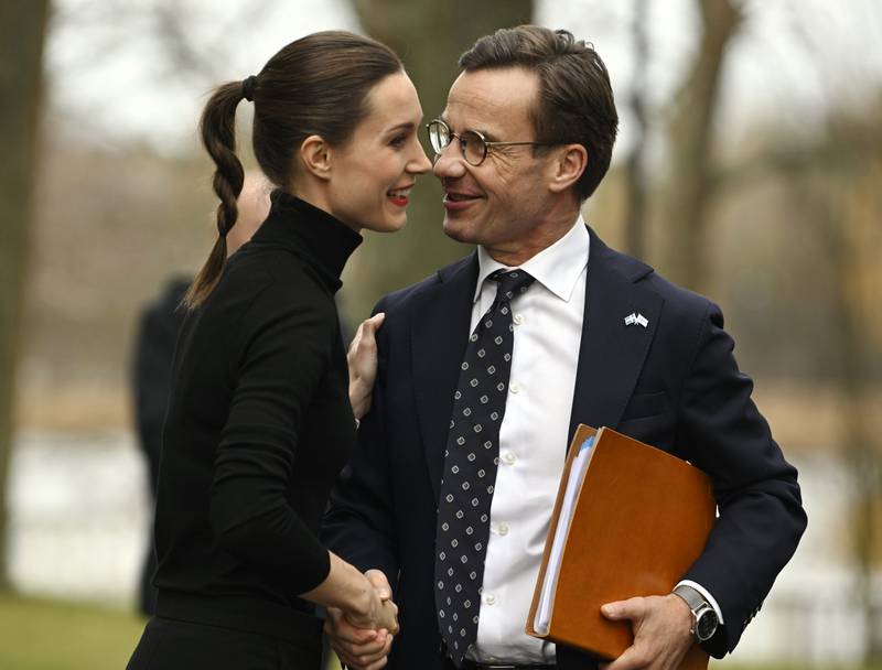 Finnish Prime Minister Sanna Marin shakes hands with her new Swedish counterpart, Ulf Kristersson, in Helsinki. AP