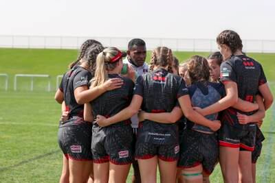 Dubai Exiles Girls U19A huddle to listen to their coach before a match.