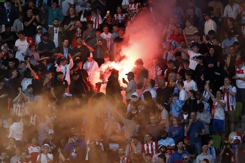Fans set off flares during the round match. Getty