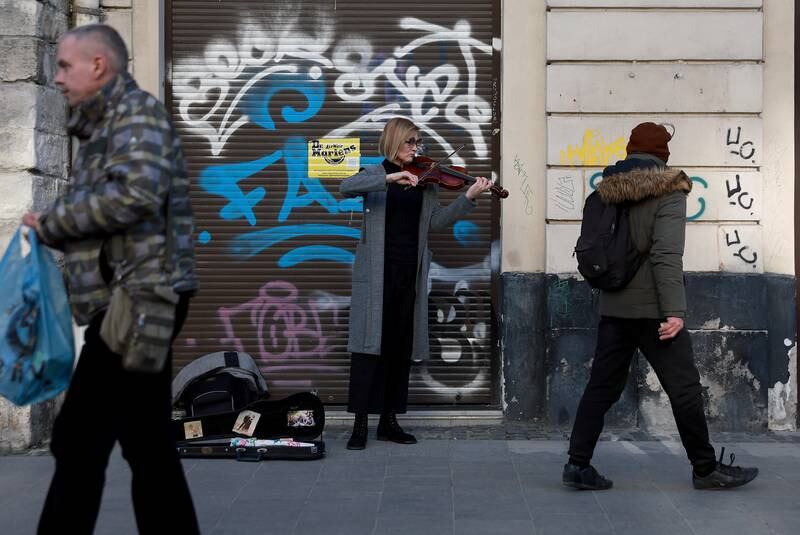 Busker Oksana Neh plays for passers-by in Lviv. Getty Images