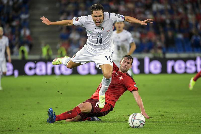 Italy's Federico Chiesa, left, fights for the ball against Switzerland's Fabian Frei during the World Cup 2022 Group C qualifying match at the St Jakob-Park Stadium in Basel, Switzerland, on Sunday, September  5, 2021. AP