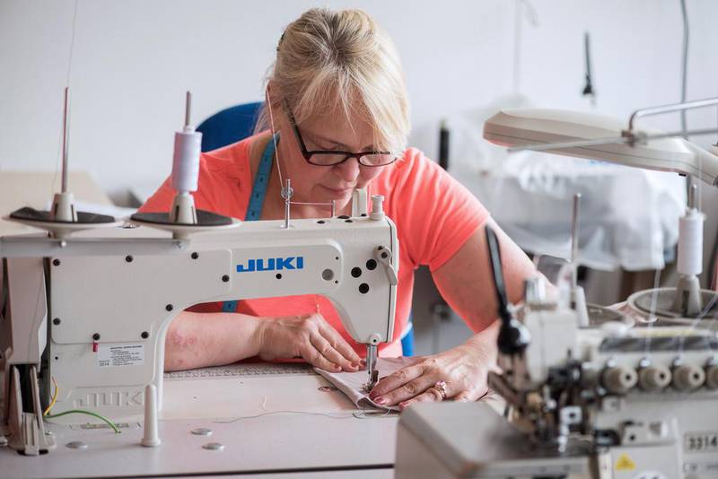 Dalia Janiusiene, a skilled machinist from Lithuania, at the London production studio of Rose and Willard, which specialises in designs for professional women. Eleanor Bentall / The National