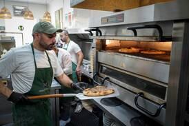 A spiced beef pastry, or a lahm bi ajeen manoushe, coming out of the oven at Z&Z bakery in Rockville, Maryland. Joshua Longmore / The National