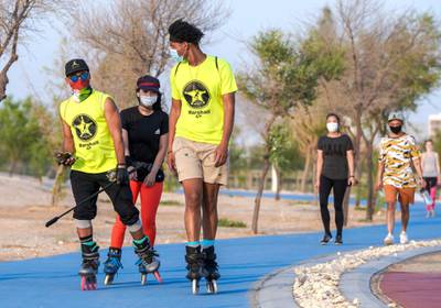 Abu Dhabi, United Arab Emirates, May 26, 2020.    Khalifa City residents wearing face masks trying to keep fit during the Eid break at Masdar Park exercise pathway during the Covid-19 pandemic.Victor Besa  / The NationalSection:  Standalone / Stock
