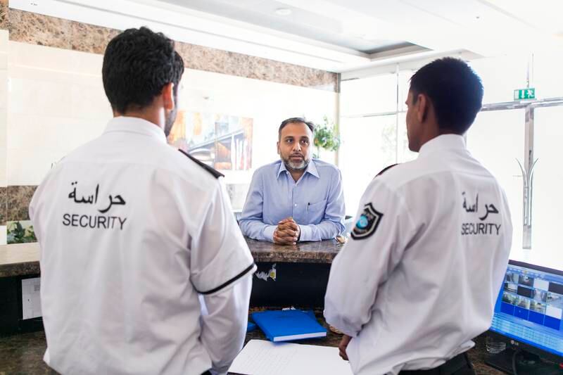 Security staff at work in the UAE. Companies that insist employees work excess hours are breaking the law. Photo: Reem Mohammed / The National