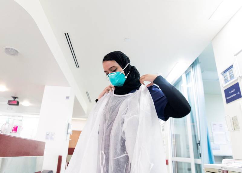 ABU DHABI, UNITED ARAB EMIRATES. MAY 2020.Medical resident at Sheikh Khalifa Medical City, Khuloud Al Haj Banimatar, puts on the PPE.(Photo: Reem Mohammed/The National)Reporter:Section: