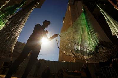 A shop worker sorts fishing nets on display at a store in Najaf. Reuters