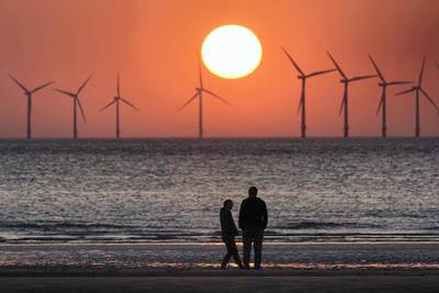WALLASEY, ENGLAND - MAY 23:  The sun sets behind the wind turbines of Burbo Bank Offshore Wind Farm in the Irish Sea on May 23, 2018 in Wallasey, England.  (Photo by Christopher Furlong/Getty Images)