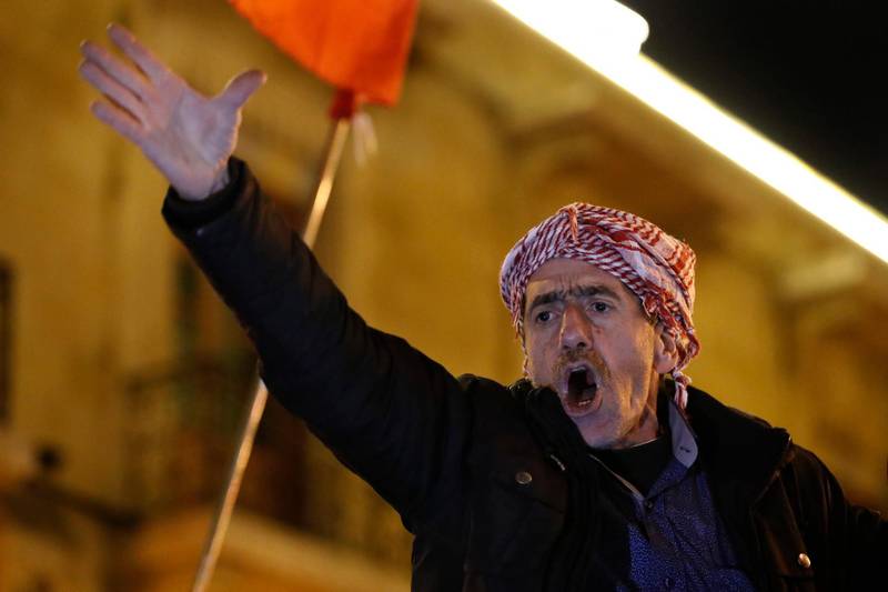 An anti-government protester shouts slogans during a protest against the new government, near the parliament square, in Beirut. AP Photo