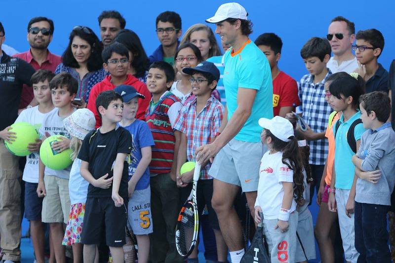 Rafael Nadal poses with fans at Zayed Sports City in Abu Dhabi on Thursday ahead of the Mubadala World Tennis Championship. Kamran Jebreili / AP