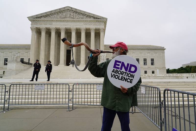 A pro-life supporter stands in front of the Supreme Court. Willy Lowry / The National