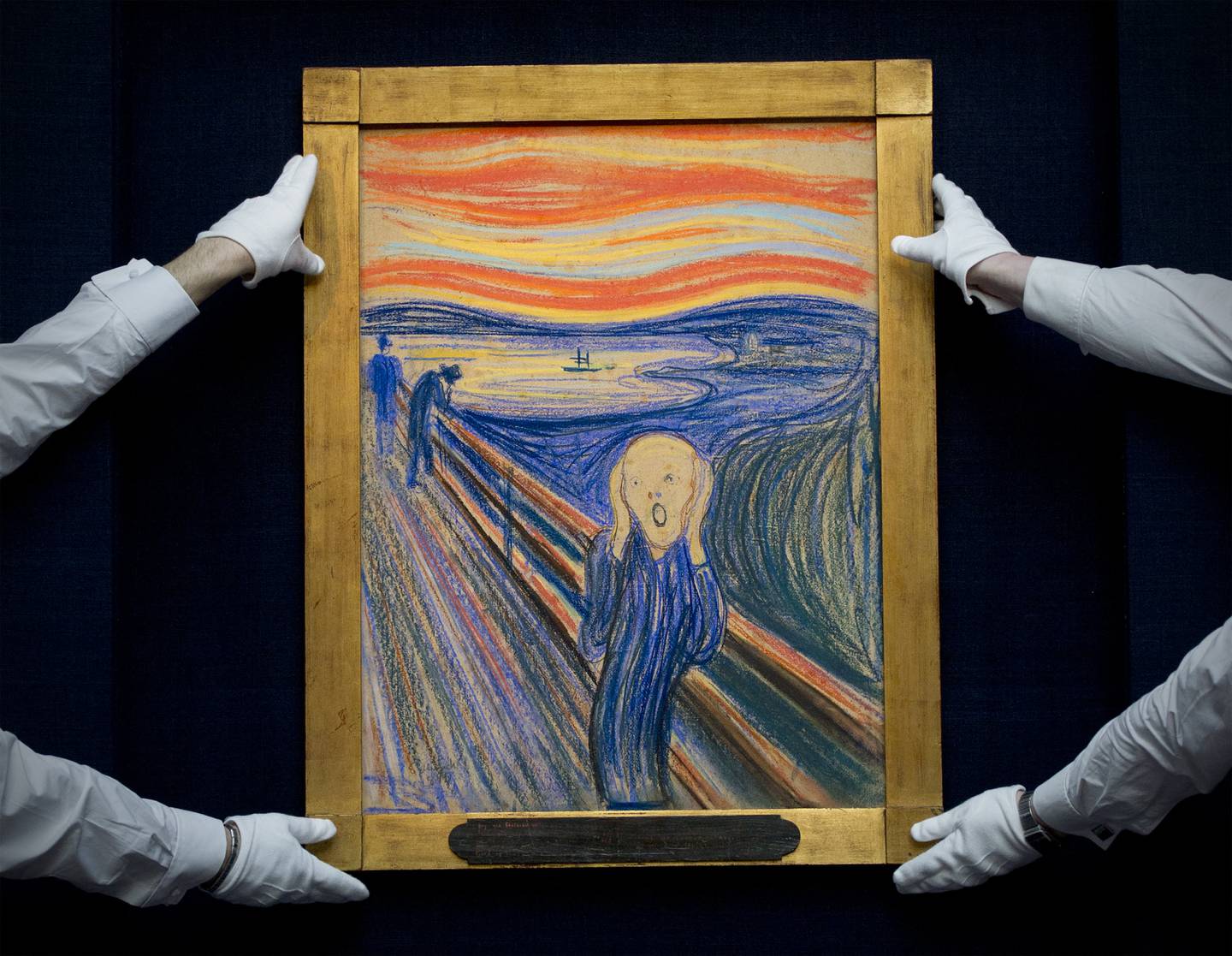 Sotheby's employees pose with Norwegian artist Edvard Munch's 1895 pastel on board version of 'The Scream' at Sotheby's auction house in central London on April 12, 2012. AFP