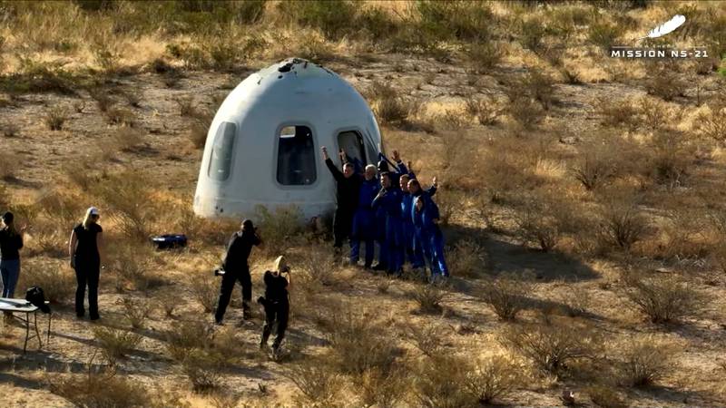 The six Blue Origin passengers land back in a Texan desert after a suborbital flight. Blue Origin via Reuters 