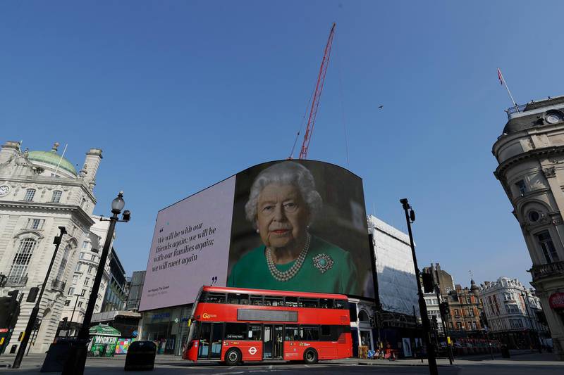 An image of Britain's Queen Elizabeth II and quotes from her historic television broadcast commenting on the coronavirus pandemic are displayed on a big screen at Piccadilly Circus in London in April 2020. AP Photo