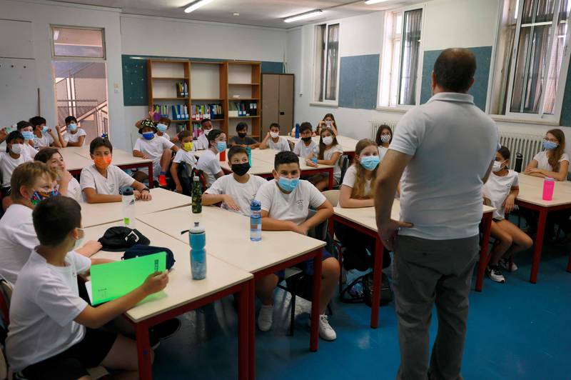 An Israeli teacher talks to pupil on the first day of the new school year. AFP