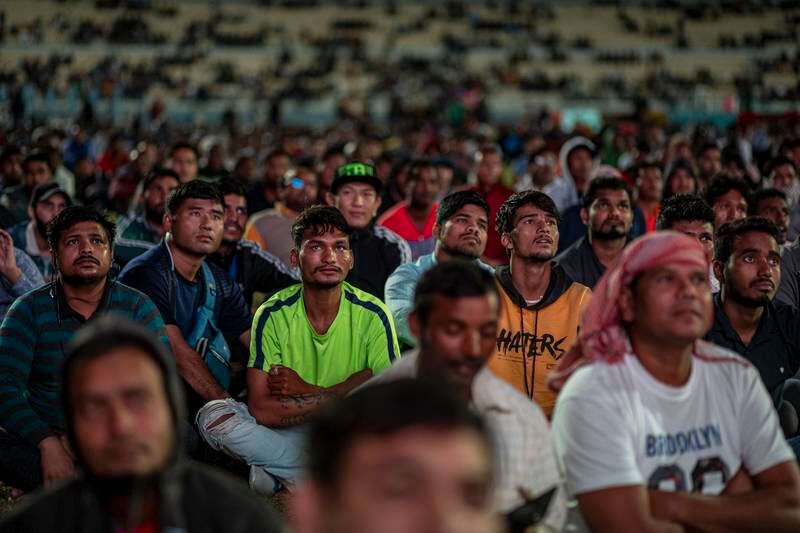 Migrant workers watch England play Iran at the free-entry World Cup Industrial Area Fan Zone in Doha. EPA