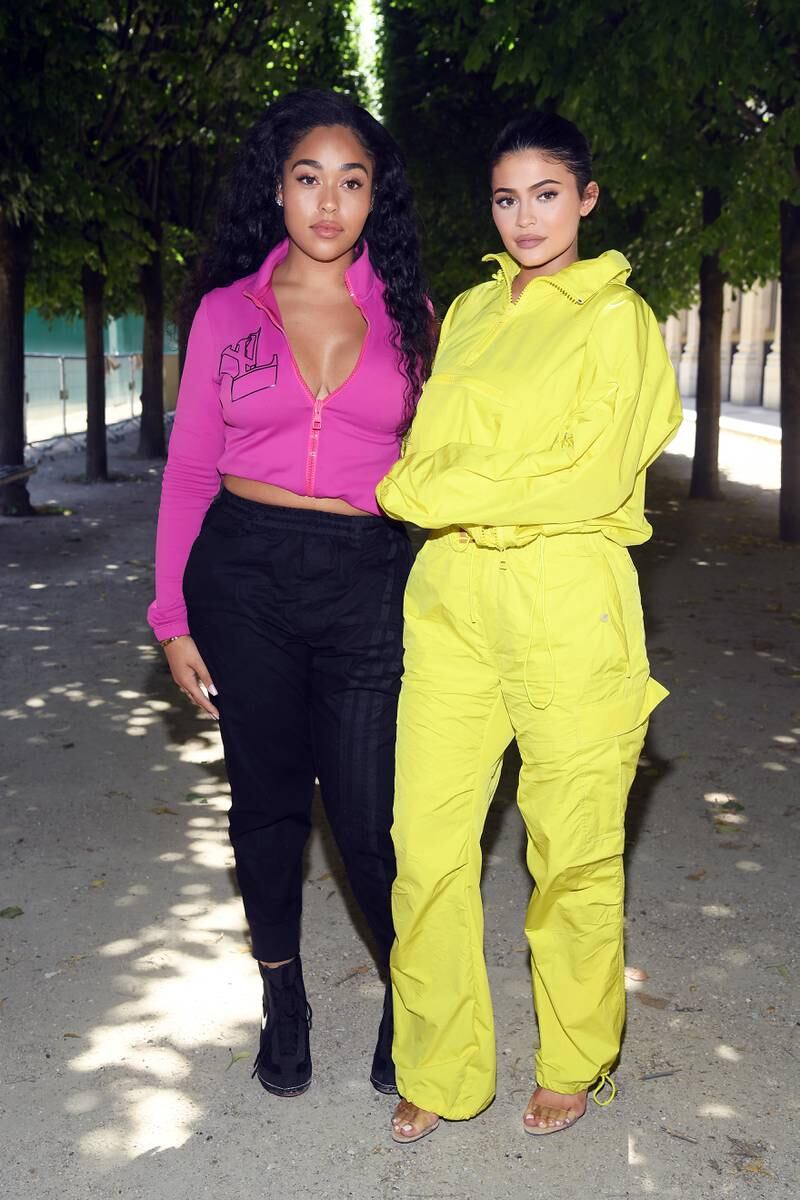 Jordyn Woods and Kylie Jenner, in a yellow Louis Vuitton tracksuit, attend the French maison's menswear spring/summer 2019 show as part of Paris Fashion Week on June 21, 2018. Getty Images