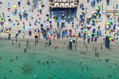 People try to escape the heat by swimming at Poetto beach in Sardinia, Italy. Bloomberg