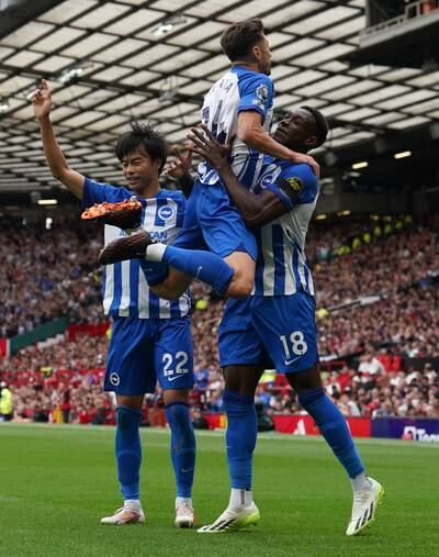 Brighton and Hove Albion's Danny Welbeck celebrates with Adam Lallana, centre, and Kaoru Mitoma, left, after scoring their first goal. PA 
