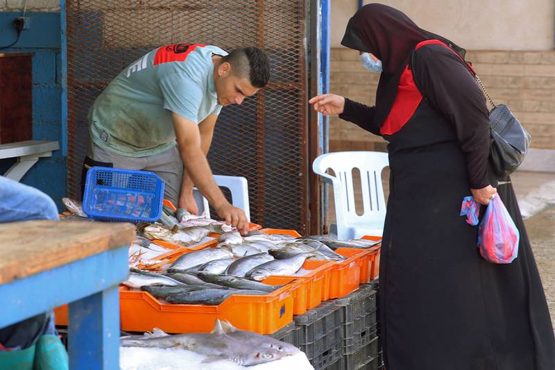 A woman shops at Tripoli's fish market. AFP