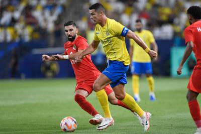 Nassr's Portuguese forward Cristiano Ronaldo is marked by Shabab Al Ahli's Israeli forward Munas Dabbur during the AFC Champions League play-off in Riyadh on Tuesday. AFP