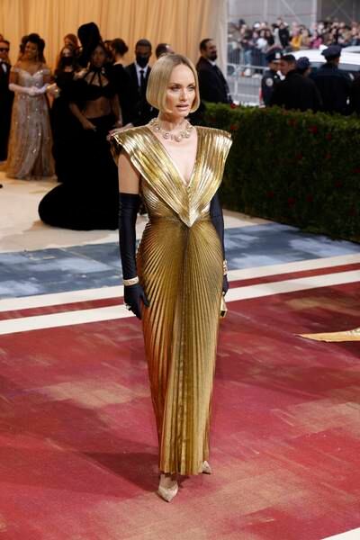 Amber Valletta, wearing a gold gown. EPA