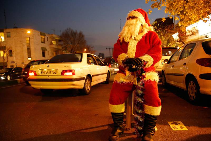 A man wears a Santa costume in a street in Tehran, Iran. EPA