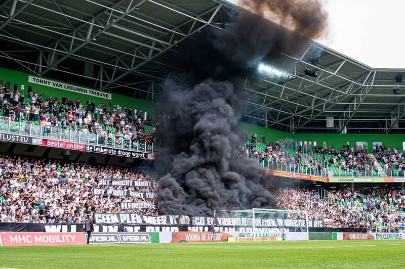 Supporters of FC Groningen ignite smoke bombs during a league match against Ajax in the Netherlands. EPA

