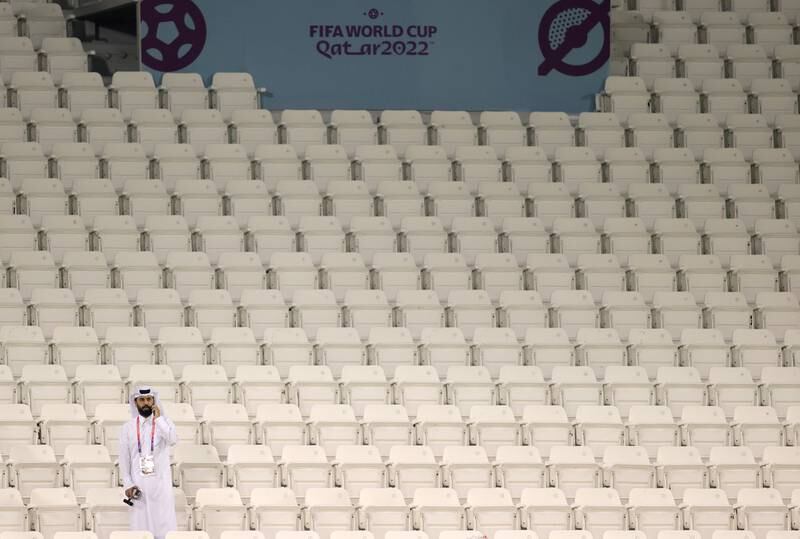 A local journalist stands on the tribune during the training session of the French national soccer team in Doha. EPA