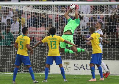 Brazil goalkeeper Alisson catches the ball during the match at King Abdullah Stadium. AP Photo