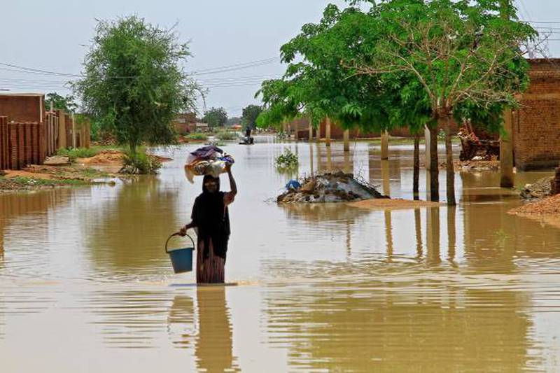 A woman wades through floodwaters in the village of Makaylab. AFP