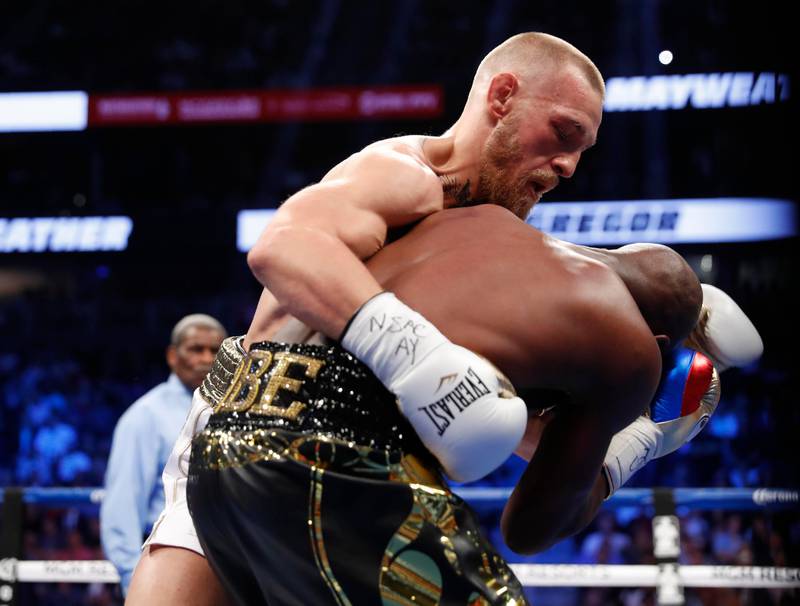 Conor McGregor in action with Floyd Mayweather. Reuters