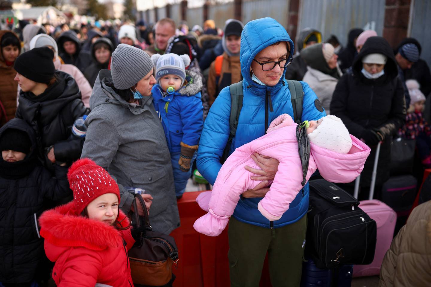 People fleeing the Russia invasion wait at the Shehyni border crossing. Reuters
