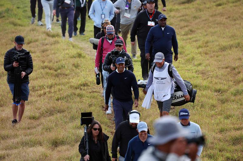 Tiger Woods walks across the 18th hole during the first round of the the Genesis Invitational. AFP