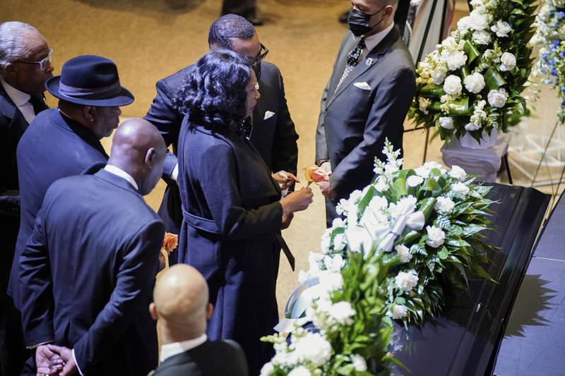 Ms Wells stops in front of the casket of her son at the start of his funeral service. AP