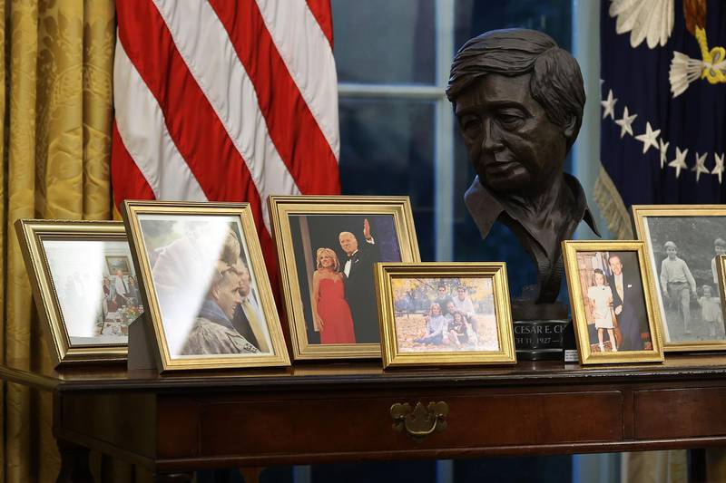 Framed photographs are seen on the table behind the Resolute Desk at the Oval Office. AFP