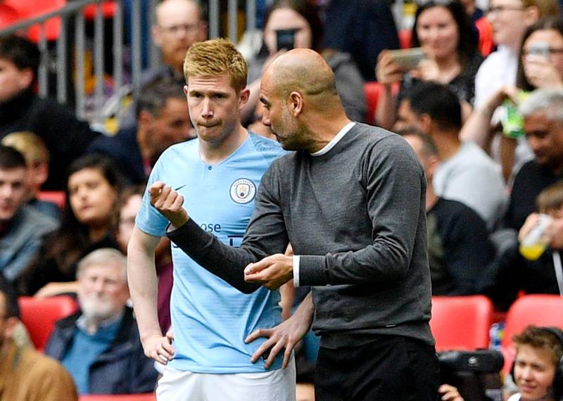 Manager Pep Guardiola talks to midfielder Manchester City Kevin de Bruyne before the Belgian midfielder joins the action in place of Riyad Mahrez. EPA