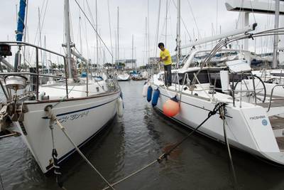A man checks ropes on a sailing boat in preparation for Typhoon Hagibis at a harbor in Fujisawa, Kanagawa Prefecture. Bloomberg