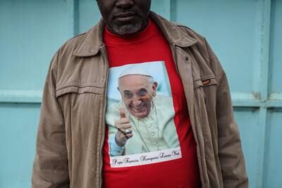 Father Paschal Mwijage of the St Joseph the Worker Parish in Nairobi's Kangemi slum wears a T-shirt featuring Pope Francis in Kenya in November 2015. Getty Images
