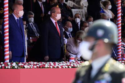 The Turkish president reviews a guard of honour with Turkish Cypriot leader Ersin Tatar. Reuters