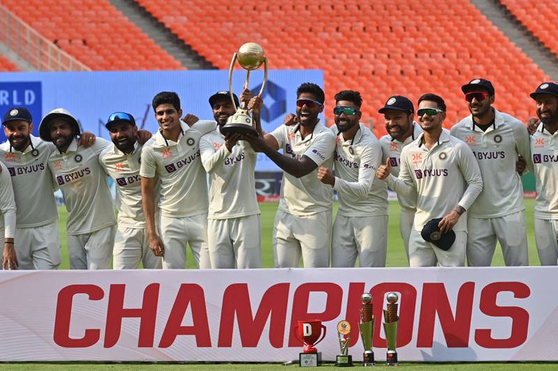 India's players pose with the Border Gavaskar Trophy after winning the series 2-1 at the end of the Ahmedabad Test against Australia. AFP