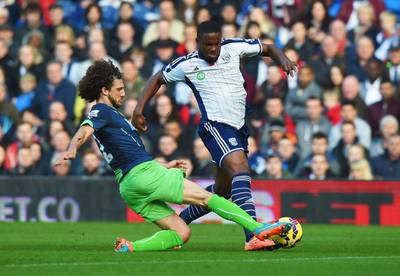 West Bromwich Albion's Victor Anichebe tries to dribble past Newcastle United's Fabricio Coloccini during their Premier League match on Sunday. Michael Regan / Getty Images / November 9, 2014 